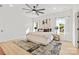 The bright main bedroom features a ceiling fan, windows with coverings, and a walk-in closet at 215 Scout Rd, Locust, NC 28097