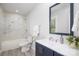 Bathroom with white marble tile, a single sink vanity and a mirror at 221 Palmer St, Albemarle, NC 28001