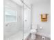 Modern bathroom with glass shower and white marble style tile surround at 221 Palmer St, Albemarle, NC 28001