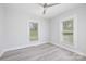 Bright bedroom with a ceiling fan and natural light provided by two windows at 221 Palmer St, Albemarle, NC 28001
