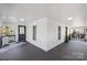 Spacious covered porch with black railings, potted plants, and outdoor seating area at 221 Palmer St, Albemarle, NC 28001