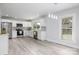 Modern, white kitchen with stainless steel appliances and light grey backsplash and flooring at 221 Palmer St, Albemarle, NC 28001
