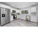 Well-lit kitchen featuring stainless steel appliances, grey tile backsplash, and ample cabinet space at 221 Palmer St, Albemarle, NC 28001