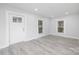 Bright living room with front door and natural light provided by two windows at 221 Palmer St, Albemarle, NC 28001