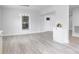 Bright living room with modern light fixture, front door and light grey flooring at 221 Palmer St, Albemarle, NC 28001