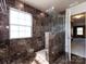Beautiful bathroom featuring marble tile, a frameless shower, and natural light from a window at 2316 Highland Park Dr, Charlotte, NC 28269