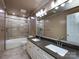 Spacious bathroom featuring a double vanity, tiled shower-tub combo, and modern fixtures at 2316 Highland Park Dr, Charlotte, NC 28269