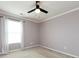 This bedroom features a ceiling fan, neutral walls, and a bright window for a calming atmosphere at 2316 Highland Park Dr, Charlotte, NC 28269