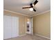 Bedroom with white trim, a ceiling fan, and double doors that lead to a bathroom at 2316 Highland Park Dr, Charlotte, NC 28269