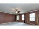 Spacious bedroom featuring a ceiling fan, large windows, and elegant curtains at 2316 Highland Park Dr, Charlotte, NC 28269