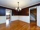 This dining area features hardwood floors, stylish wainscoting, and an elegant chandelier at 2316 Highland Park Dr, Charlotte, NC 28269