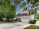 Well-maintained two-story home with a long driveway, attached garage, and lush green lawn at 2316 Highland Park Dr, Charlotte, NC 28269