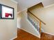 Entryway featuring hardwood floors, a staircase with white railings, and a framed mirror at 2316 Highland Park Dr, Charlotte, NC 28269