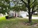 Charming two-story home with a well-manicured lawn, red door, and attached garage at 2316 Highland Park Dr, Charlotte, NC 28269