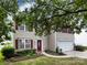 Charming two-story home with red shutters, a well-manicured lawn, and mature trees providing shade at 2316 Highland Park Dr, Charlotte, NC 28269