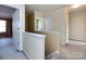 Bright hallway featuring neutral walls, white trim, and a view into an adjacent room at 2316 Highland Park Dr, Charlotte, NC 28269