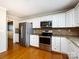 Eat-in kitchen features stainless steel appliances, granite countertops, and hardwood floors at 2316 Highland Park Dr, Charlotte, NC 28269