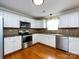 This well-lit kitchen offers stainless steel appliances, granite countertops, and white cabinetry at 2316 Highland Park Dr, Charlotte, NC 28269