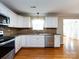 This well-lit kitchen offers stainless steel appliances, granite countertops, and white cabinetry at 2316 Highland Park Dr, Charlotte, NC 28269