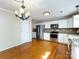 Eat-in kitchen features stainless steel appliances, granite countertops, and hardwood floors at 2316 Highland Park Dr, Charlotte, NC 28269