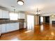 Open concept living area connects to a modern kitchen and features hardwood floors at 2316 Highland Park Dr, Charlotte, NC 28269