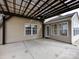 Covered patio adjacent to a house with outdoor ceiling fan at 2316 Highland Park Dr, Charlotte, NC 28269