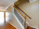 Carpeted staircase with white wood trim, hardwood floors, and neutral-toned walls at 2316 Highland Park Dr, Charlotte, NC 28269