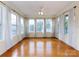 Bright sunroom with hardwood floors and abundant natural light from large windows at 2316 Highland Park Dr, Charlotte, NC 28269