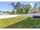 Large, well-maintained backyard featuring a privacy fence and a patio with seating at 3119 Auten Ave, Charlotte, NC 28269