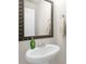 Pedestal sink in a simple bathroom with stylish mirror and towel ring, creating a minimalist design at 3119 Auten Ave, Charlotte, NC 28269