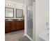 Bathroom featuring double sinks, a bathtub, and a glass enclosed shower at 3119 Auten Ave, Charlotte, NC 28269