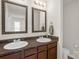 Bathroom featuring double sinks and a vanity with framed mirrors above at 3119 Auten Ave, Charlotte, NC 28269