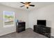 Bedroom with window, ceiling fan, dresser and TV at 3119 Auten Ave, Charlotte, NC 28269
