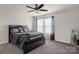 Comfortable bedroom with a ceiling fan, window, and a stylish black bed frame at 3119 Auten Ave, Charlotte, NC 28269