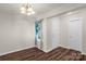 Entryway featuring hardwood floors, a chandelier, and ample natural light from the adjacent window at 3119 Auten Ave, Charlotte, NC 28269