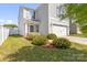 Two-story home with gray siding and a well-maintained front yard featuring lush landscaping at 3119 Auten Ave, Charlotte, NC 28269