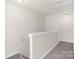 Second floor hallway with carpeting, neutral paint, and access to rooms, all bathed in natural light at 3119 Auten Ave, Charlotte, NC 28269