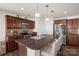 Well-equipped kitchen with stainless steel appliances, a breakfast bar, and dark wood cabinetry at 3119 Auten Ave, Charlotte, NC 28269