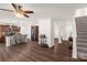 Open-concept living room with hardwood floors, kitchen island, and staircase to the second floor at 3119 Auten Ave, Charlotte, NC 28269