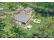 Aerial view of the property showcases the house, yard, firepit, outbuilding, and surrounding greenery at 3232 Kale Ln, Matthews, NC 28105