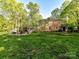 Large, well-maintained backyard with a fire pit, seating, and access to the house and porch, perfect for entertaining at 3232 Kale Ln, Matthews, NC 28105