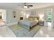 Bedroom with neutral colors, ceiling fan, and access to an ensuite bathroom at 3232 Kale Ln, Matthews, NC 28105