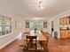 Spacious dining room with a large table, built-in shelving, and natural light from multiple windows at 3232 Kale Ln, Matthews, NC 28105