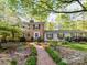 Inviting brick home with a charming front entrance and a meticulously landscaped brick walkway at 3232 Kale Ln, Matthews, NC 28105