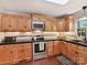 Well-lit kitchen with wood cabinets, granite countertops, and stainless steel appliances at 3232 Kale Ln, Matthews, NC 28105