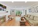 Bright living room with hardwood floors, a fireplace, and a large window overlooking the yard at 3232 Kale Ln, Matthews, NC 28105