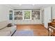 Bright living room featuring built-in bookcases, large windows and hardwood floors at 3232 Kale Ln, Matthews, NC 28105