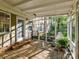 Relaxing screened-in porch with brick flooring and a hanging chair at 3232 Kale Ln, Matthews, NC 28105
