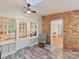 Cozy sunroom with brick accent wall and lots of natural light at 3232 Kale Ln, Matthews, NC 28105