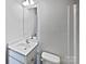 A well-lit bathroom featuring a white vanity, toilet, and large mirror at 3357 Ellingford Rd, Charlotte, NC 28214